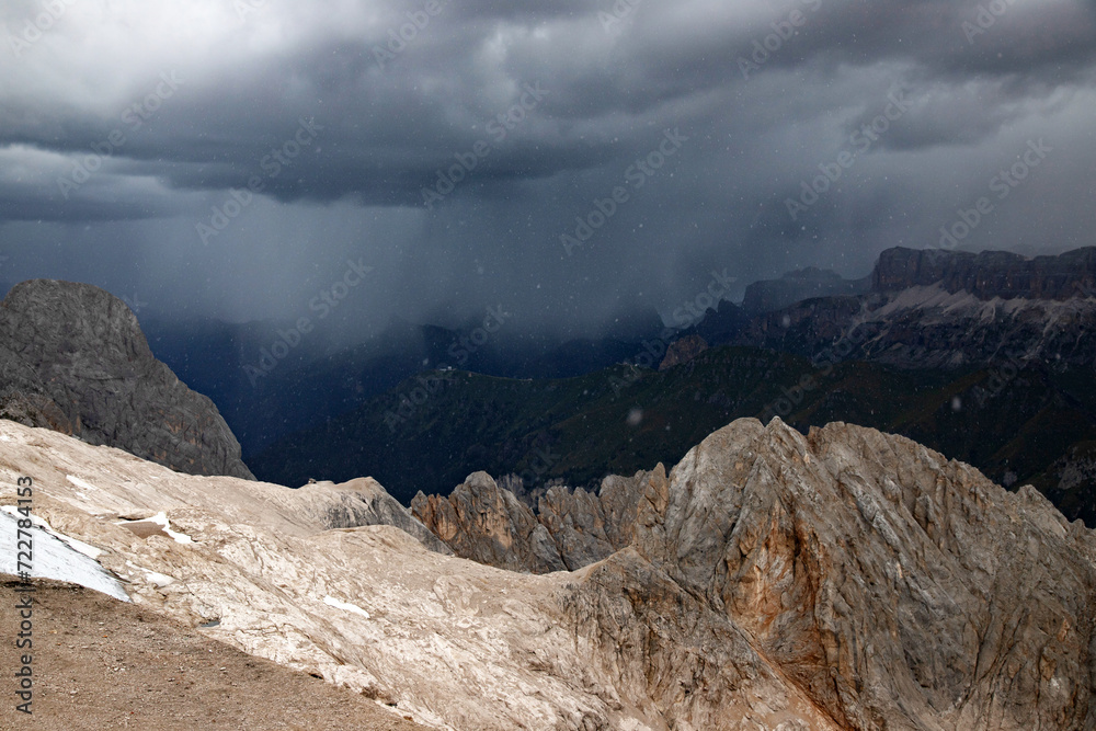 The view of Sassolungo and the Sella Group from Serauta in stormy weather in the Dolomites, Italy.