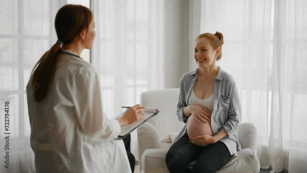 Pregnant woman consulting with a doctor. Smiling pregnant woman patient answers gynecologist questions at hospital, home, medical clinic. Doctor examine pregnant belly check up. Gynecology concept. Pregnant woman consulting with a doctor. Smiling pregnant woman patient answers gynecologist questions at hospital, home, medical clinic. Doctor examine pregnant belly check up. Gynecology concept.