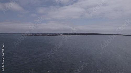 Wallpaper Mural Ungraded wide-angle aerial drone footage flying above the Pacific Ocean toward shore on a cloudy day at Westport, Washington. Torontodigital.ca