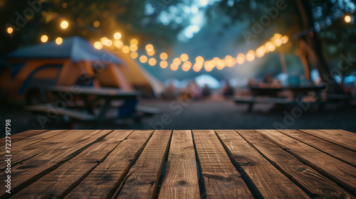 Wooden table on blur tent camping at night background	 photo