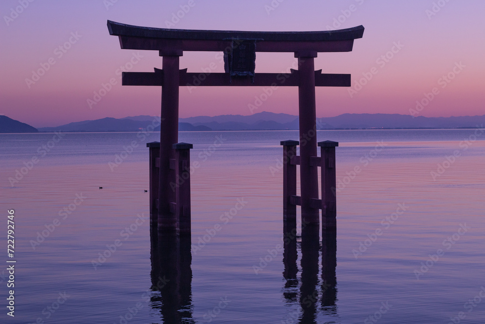 Beautiful dusk of a grand torii gate at Lake Biwa (Biwako), Takashima, Shiga, Japan. Silhouette. Copy space Beautiful dusk of a grand torii gate at Lake Biwa (Biwako), Takashima, Shiga, Japan. Silhouette. Copy space