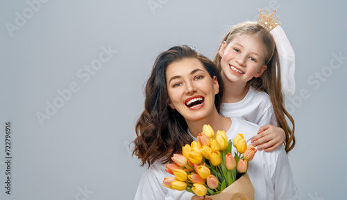 Daughter and mother with bouquet of flowers