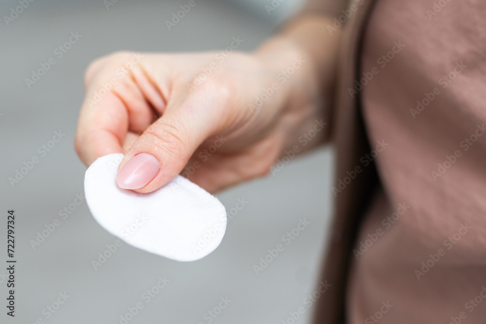 Female hand holding cotten pad. Beauty, spa, body care. Make-up removal Female hand holding cotten pad. Beauty, spa, body care. Make-up removal