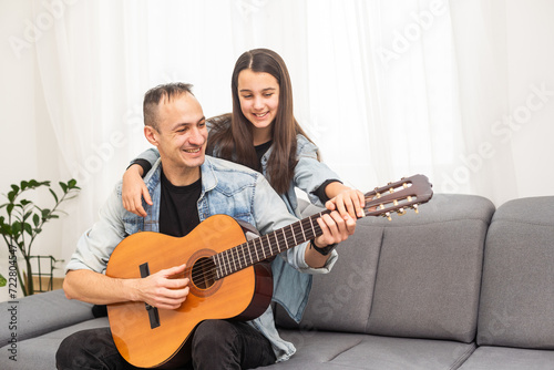 Guitar teacher teaching the little girl