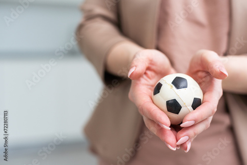 Woman hand with football on white background