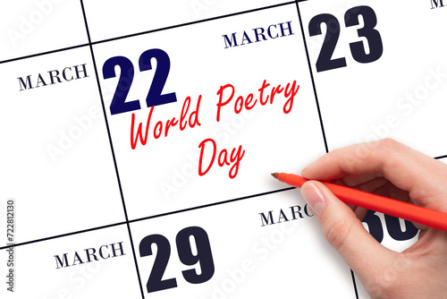 March 22. Hand writing text World Poetry Day on calendar date. Save the date.