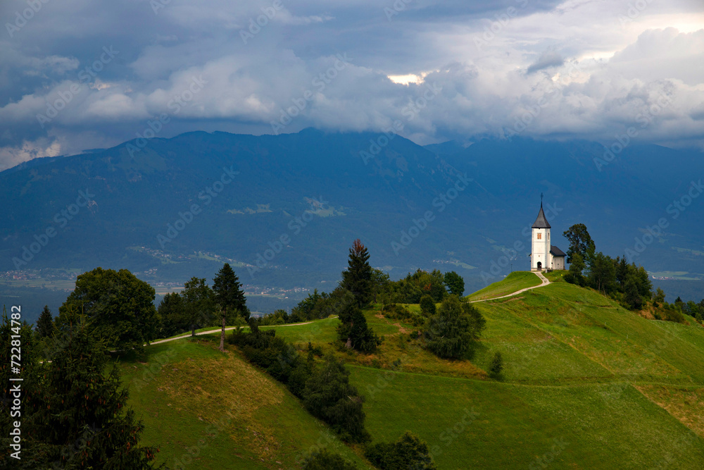 Fototapeta premium Jamnik, Slovenia - Magical cloudy summer day at Jamnik St.Primoz church.