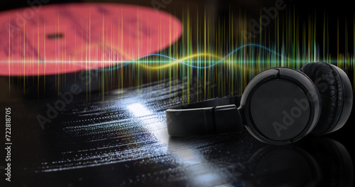 Headphones and sound wave on background of macro photo of vinyl record. Abstract musical background and audiophile concept