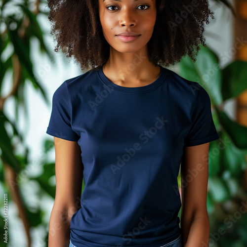 Navy BlueT-shirt Mockup, Black Woman, Girl, Female, Model, Wearing a Dark Blue Tee Shirt and Blue Jeans, Fitted Blank Shirt Template, Standing in a Room with Plants, Close-up View