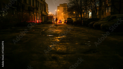A dark street with light at the end in the city at the night 