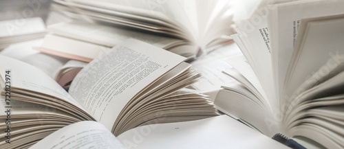 stack of books, close up. Open book on the table in library. Back to school concept. Open book on table with blur bookshelf background