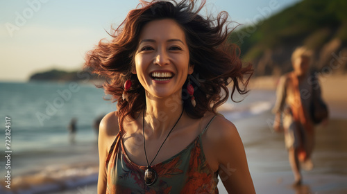 Laughing vivacious blond woman with a sense of humour standing on a tropical beach with copy space