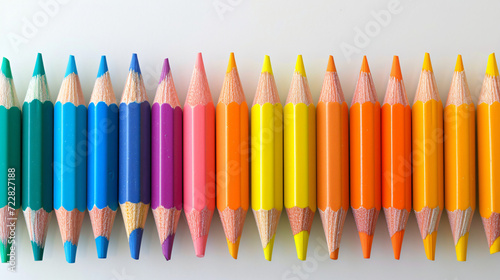 Studio shot of row of colored pencils lying