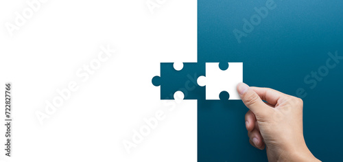 Fototapeta Naklejka Na Ścianę i Meble -  Joint venture, partnership, Mergers and acquisition concept, businessman hand connecting puzzle pieces, copy space
