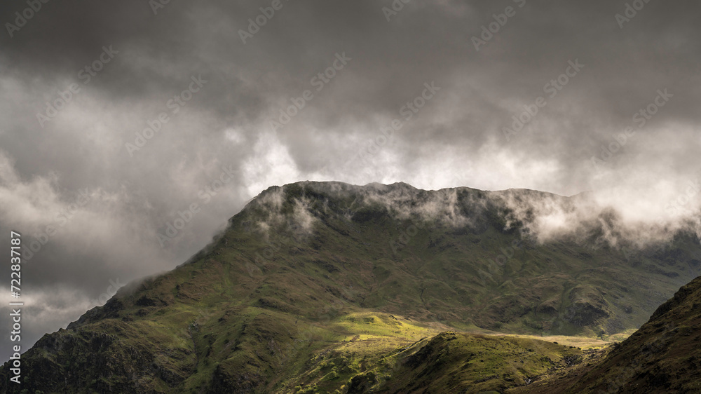 Misty foggy landscape with low clouds hanging over the mountains and lakes of Snowdonia, North Wales UK Misty foggy landscape with low clouds hanging over the mountains and lakes of Snowdonia, North Wales UK
