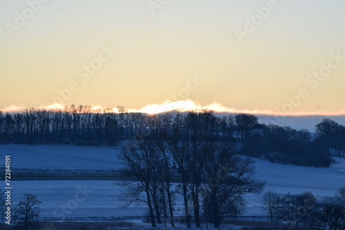 winter sunrise above snow covered land