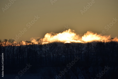 winter sunrise above snow covered land photo