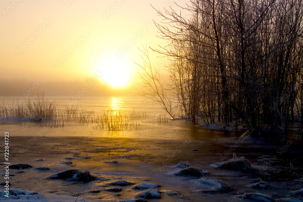 Misty sunrise at the lake shore in a lovely morning Misty sunrise at the lake shore in a lovely morning