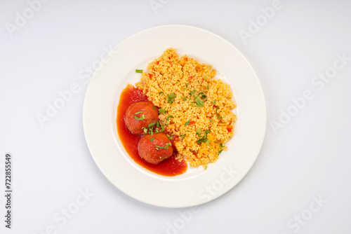 Business lunch. Meat balls in tomato sauce with a side dish of cereals and vegetables on a white background (ID: 722855549)