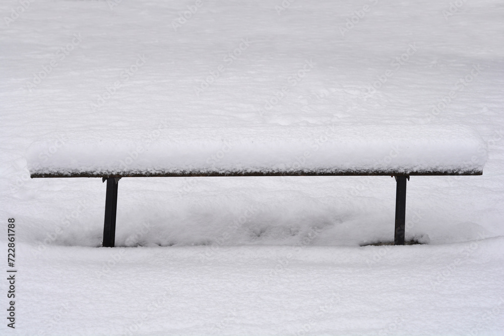 Bench covered in snow in winter Bench covered in snow in winter
