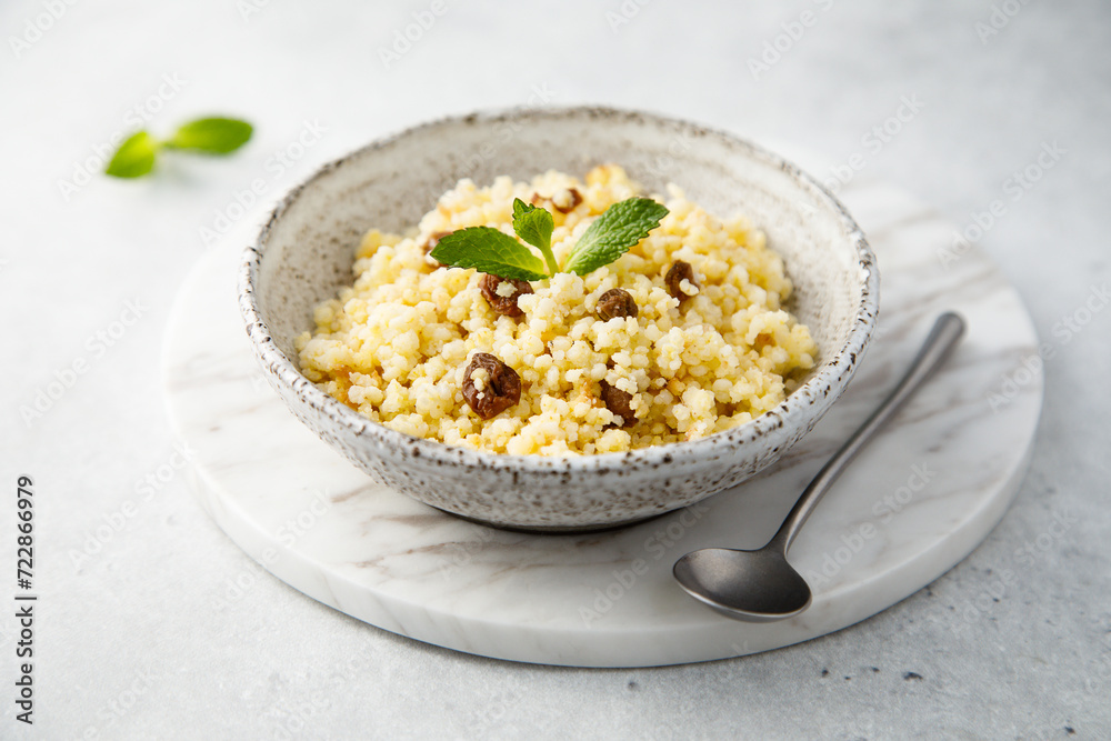 Traditional homemade millet porridge with raisins Traditional homemade millet porridge with raisins
