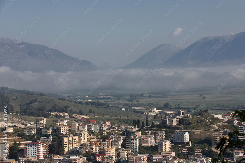 Panoramic view of the lower buildings on the slope of the Mali i Gjere massif, fog-covered Drino river valley. Gjirokaster-Albania-195