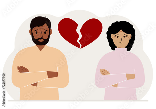 Sad man and woman next to a broken red heart. Broken heart