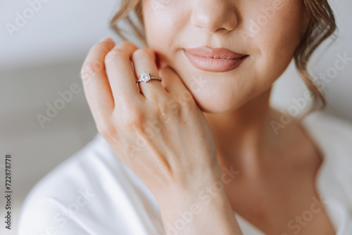 tender hands of a young woman with an expensive ring and a beautiful manicure. Close-up photo of female hands