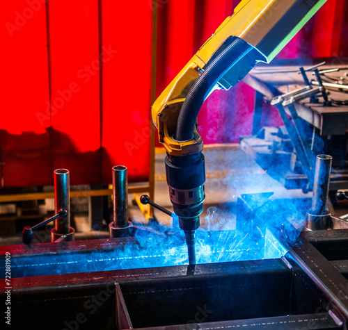 Closeup robot arm metal Argon Welding Machine working. Robotic technology in precious automation and manufacturing industry