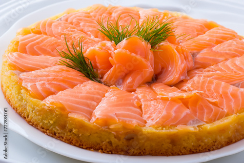 salmon cake. large cake with fresh slices of red salmon, dill on top, fish pie concept
