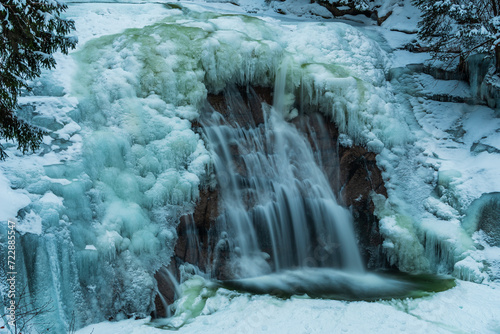 The frozen Mumlava waterfall in Krkonose national park in winter.  photo