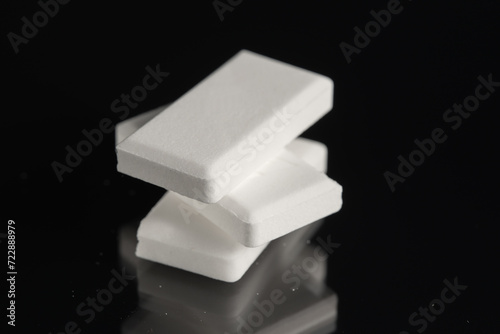 Stack of glucose dextrose candies on black background. Close-up.