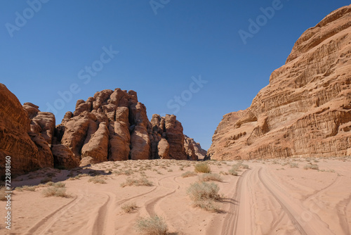 Dusty Dirt Road Stretching Through Wadi Rum Desert in Jordan