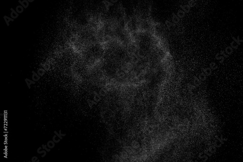 Abstract splashes of water on black background. Freeze motion of white particles. Rain, snow overlay texture.	
