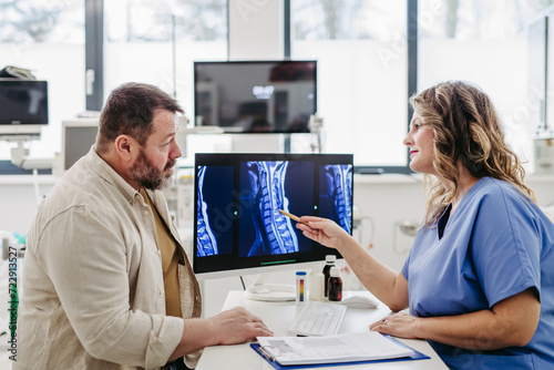Photos Doctor consulting with overweight patient, discussing test result and x-ray scans in doctor office