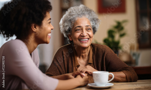 Catching Up: Ethnic Senior Female Best Friends in Kitchen with Coffee