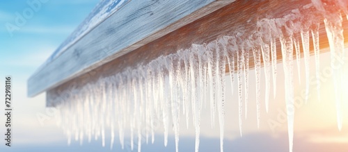 Icicle on the eaves of the roof on a winter day. Creative Banner. Copyspace image © HN Works