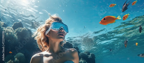 girl snorkeling underwater in the sea corals and fish. Creative Banner. Copyspace image photo