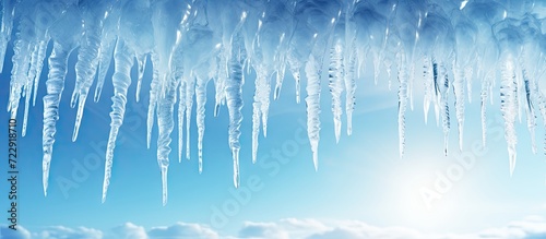 Icicles hanging from roof of house Winter concept Closeup danger icicles Frozen climate pattern Frost winter season. Creative Banner. Copyspace image