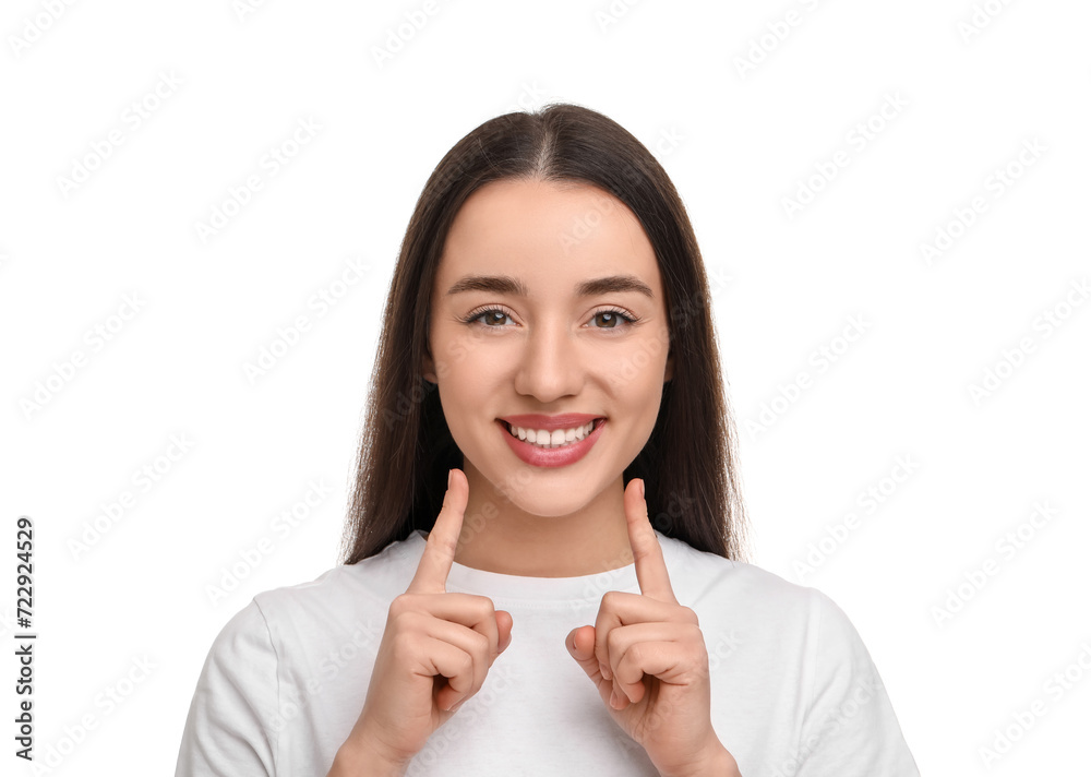 Young woman pointing at her clean teeth and smiling on white background Young woman pointing at her clean teeth and smiling on white background
