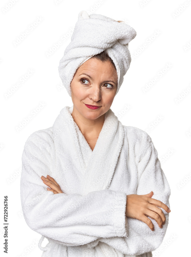 Caucasian woman in bathrobe and towel dreaming of achieving goals and purposes Caucasian woman in bathrobe and towel dreaming of achieving goals and purposes