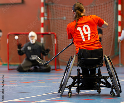 Disabled floorball player trying to score at an important championship game