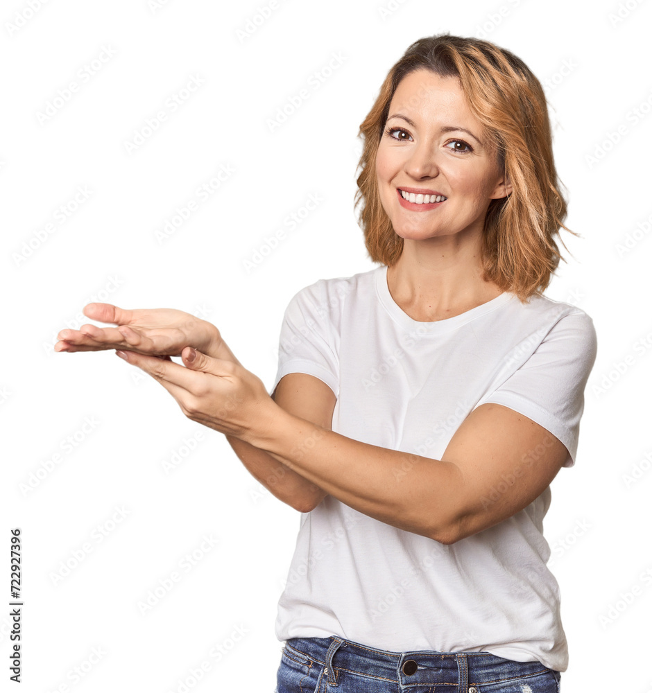 Blonde middle-aged Caucasian woman in studio holding a copy space on a palm. Blonde middle-aged Caucasian woman in studio holding a copy space on a palm.