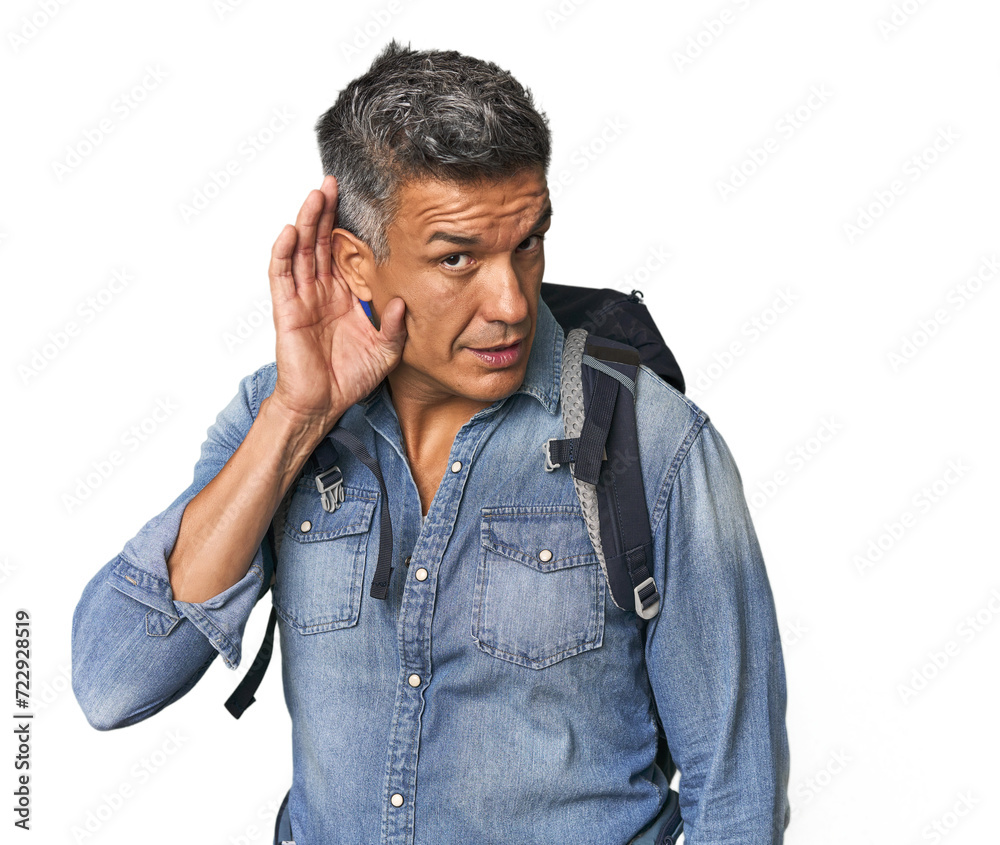 Hispanic hiker with backpack and flask trying to listening a gossip. Hispanic hiker with backpack and flask trying to listening a gossip.