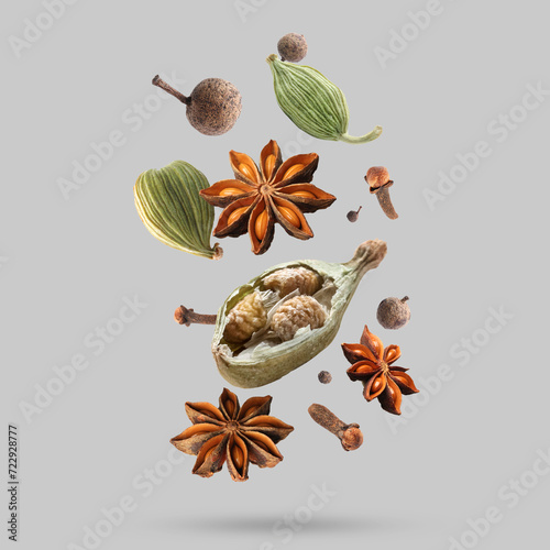 Fototapeta Naklejka Na Ścianę i Meble -  Different spices falling on light grey background