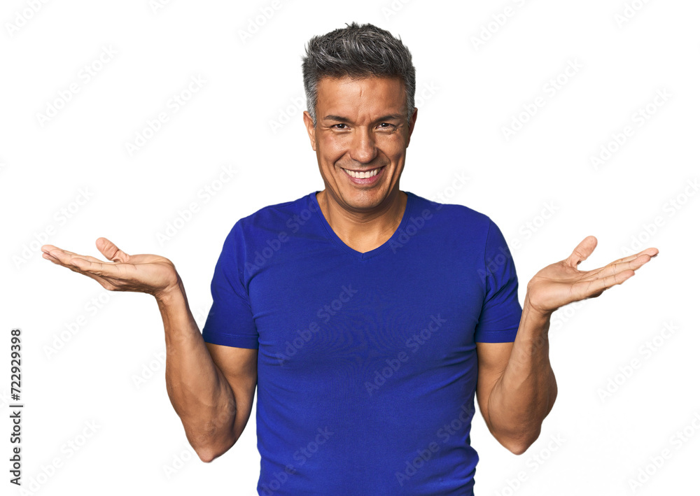 Middle-aged Latino man makes scale with arms, feels happy and confident. Middle-aged Latino man makes scale with arms, feels happy and confident.