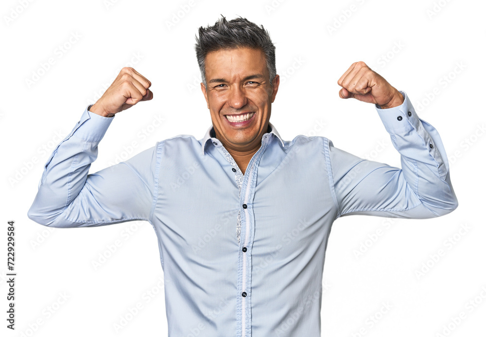 Middle-aged Latino man showing strength gesture with arms, symbol of feminine power Middle-aged Latino man showing strength gesture with arms, symbol of feminine power