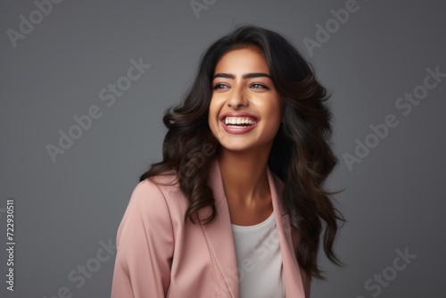 Portrait of a smiling young woman of Indian ethnicity having long flowing hair