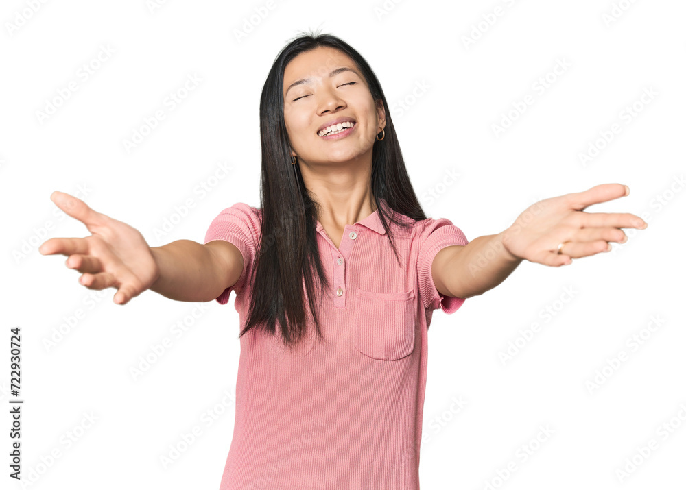 Young Chinese woman in studio setting feels confident giving a hug to the camera. Young Chinese woman in studio setting feels confident giving a hug to the camera.