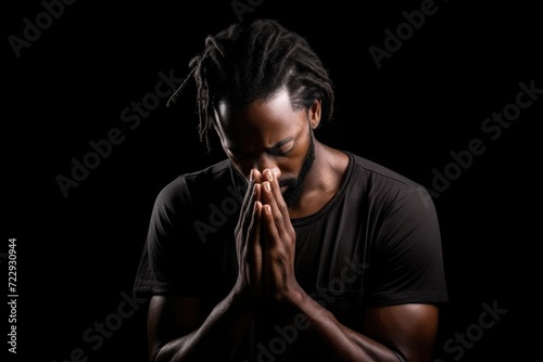 Black History Month, african american man praying on black background, praying to god with religious
